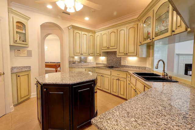 221 Asphodel Dr, Dothan, AL 36303 - kitchen featuring ceiling fan, cream cabinets, light tile patterned flooring, arched walkways, and glass insert cabinets