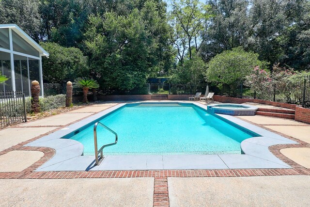 221 Asphodel Dr, Dothan, AL 36303 - view of pool with a fenced backyard, a patio, a pool with connected hot tub, and view of scattered trees