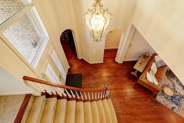 221 Asphodel Dr, Dothan, AL 36303 - stairs with arched walkways, a high ceiling, a chandelier, and wood finished floors