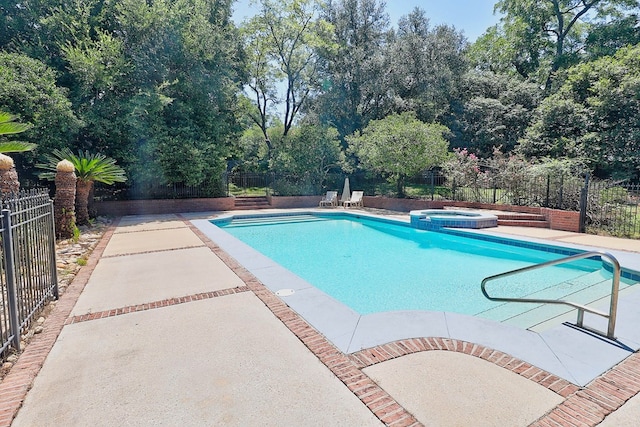 221 Asphodel Dr, Dothan, AL 36303 - view of swimming pool with a pool with connected hot tub, a patio area, and view of scattered trees