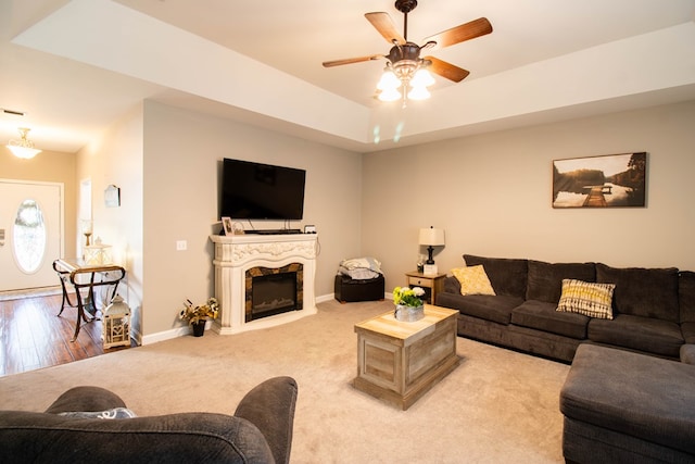 living room with ceiling fan and light hardwood / wood-style flooring