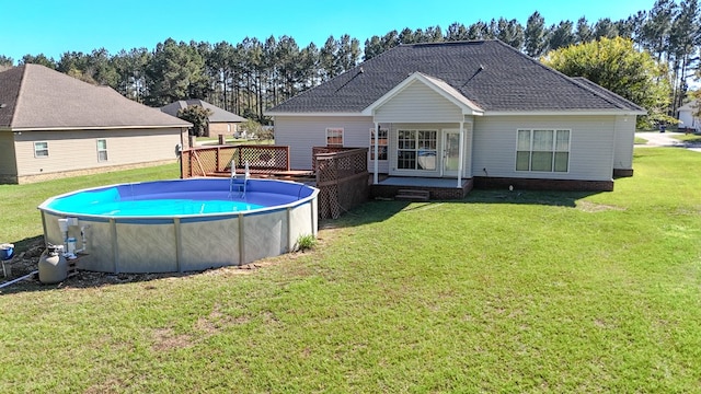 view of pool featuring a yard and a wooden deck