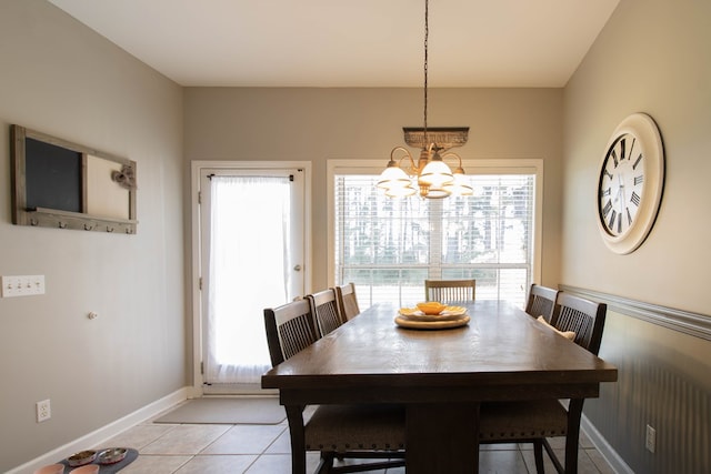 tiled dining room with a notable chandelier