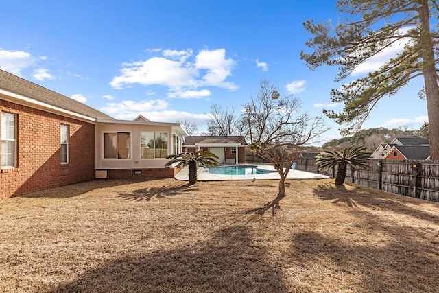 view of yard with a fenced in pool and an outdoor structure