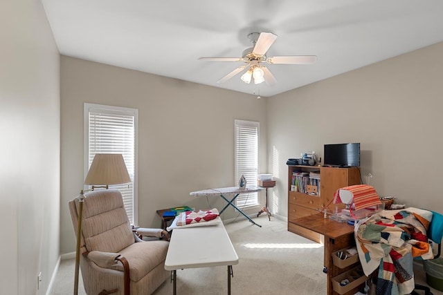 carpeted home office with ceiling fan