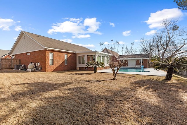 back of house with a fenced in pool, central air condition unit, and a patio area