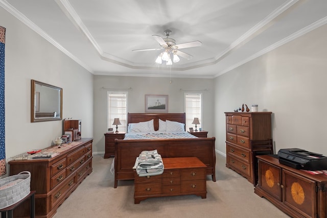 bedroom featuring ceiling fan, crown molding, light carpet, and a raised ceiling