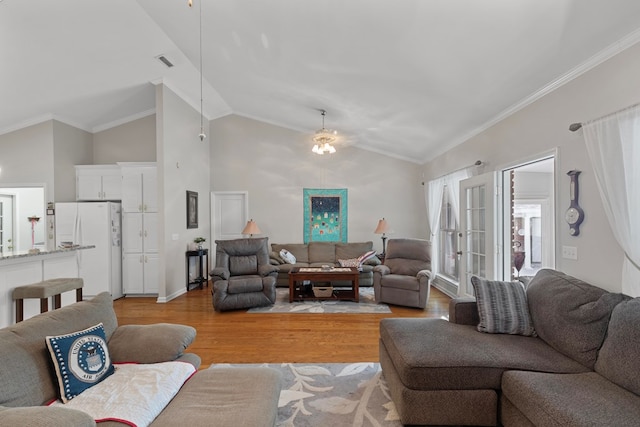 living room featuring light hardwood / wood-style floors, high vaulted ceiling, and ornamental molding