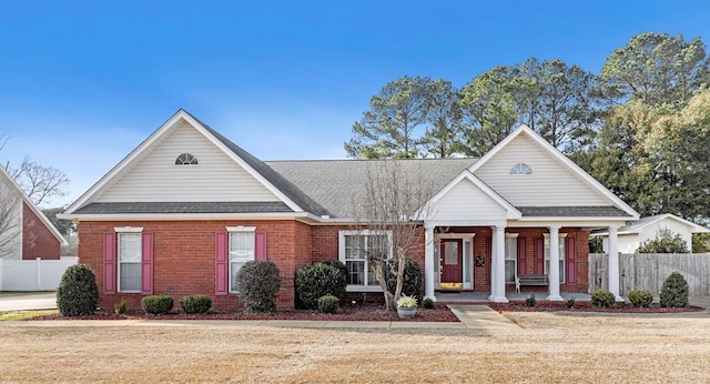 view of front of property featuring covered porch and a front lawn