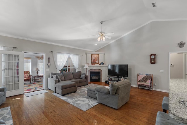 living room with vaulted ceiling, ceiling fan, crown molding, and hardwood / wood-style flooring