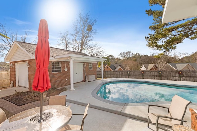 view of swimming pool featuring a patio area and an outdoor structure