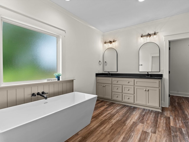 328 Lakes Dr, Enterprise, AL 36330 - full bathroom with a sink, double vanity, a soaking tub, and wood finished floors