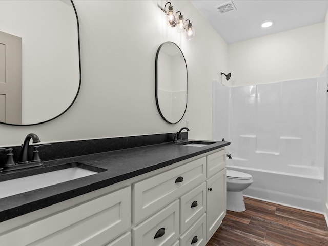 328 Lakes Dr, Enterprise, AL 36330 - full bath featuring toilet, visible vents, a sink, and wood finished floors