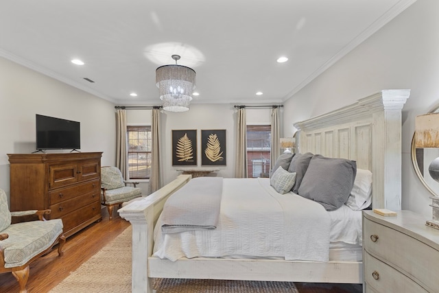 bedroom with light wood-type flooring, ornamental molding, and a notable chandelier