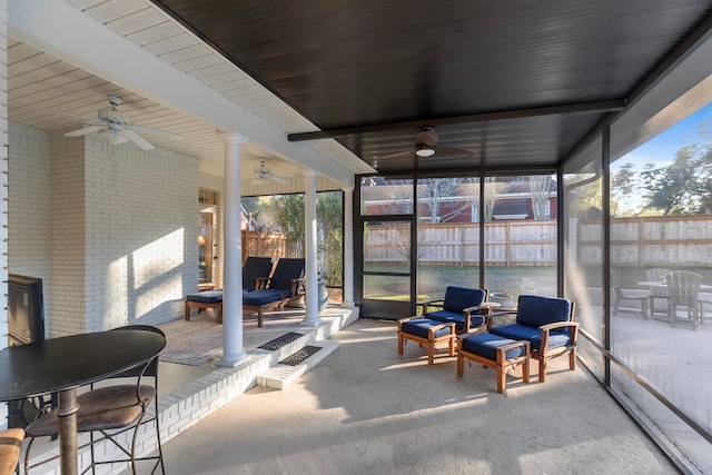 sunroom / solarium featuring ornate columns