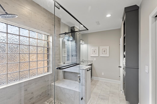 bathroom featuring vanity, a shower with door, and crown molding