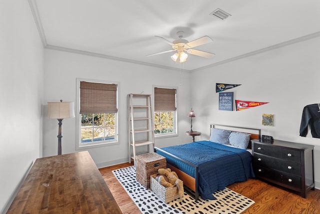 bedroom featuring wood-type flooring, ceiling fan, and crown molding