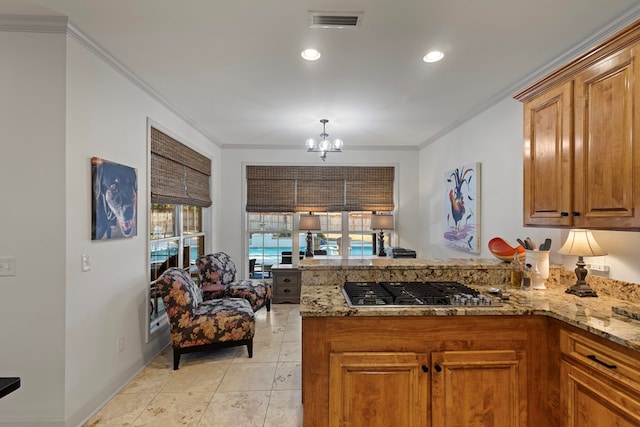 kitchen with stainless steel gas stovetop, kitchen peninsula, ornamental molding, and a notable chandelier