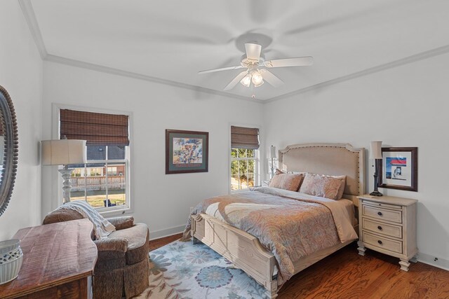 bedroom with dark hardwood / wood-style floors, ceiling fan, and ornamental molding