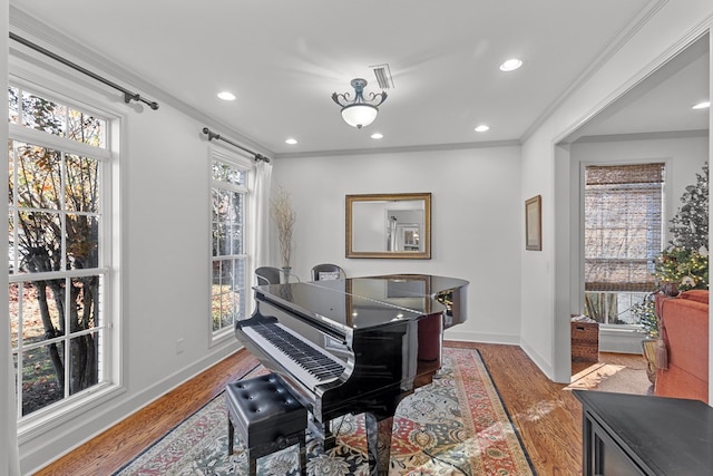 miscellaneous room featuring light hardwood / wood-style floors and crown molding