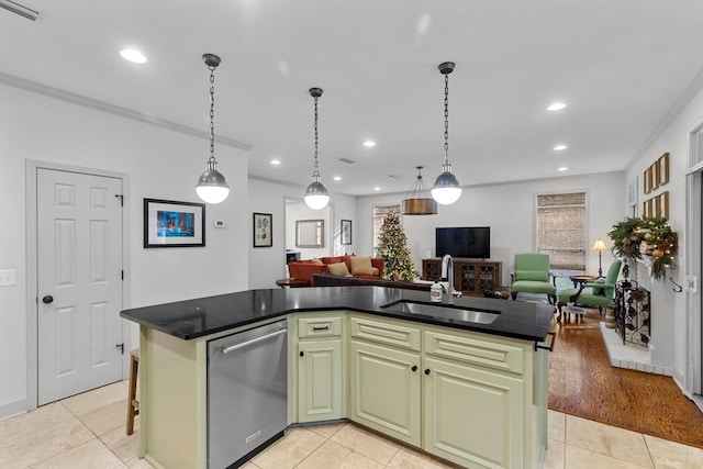 kitchen featuring a kitchen island with sink, sink, light tile patterned floors, and stainless steel dishwasher