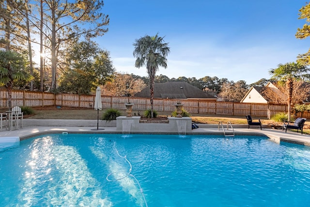 view of swimming pool featuring pool water feature and a patio area