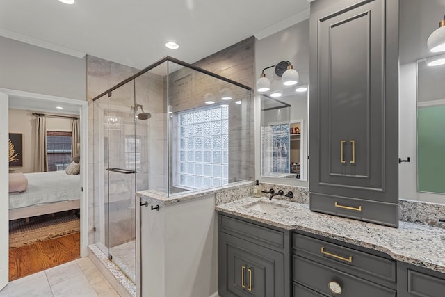 bathroom featuring tile patterned flooring, vanity, an enclosed shower, and ornamental molding