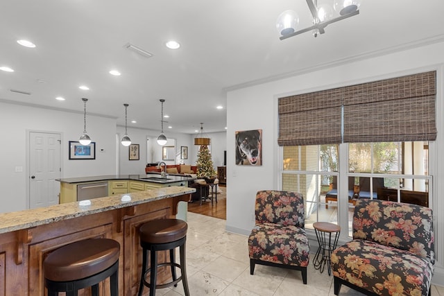 kitchen with sink, stainless steel dishwasher, dark stone countertops, ornamental molding, and light tile patterned floors