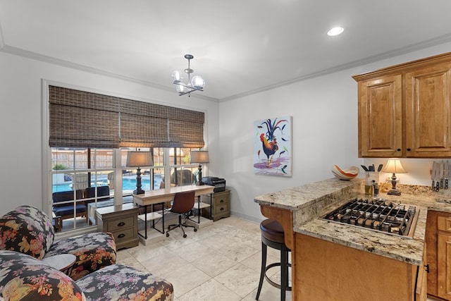 kitchen featuring a breakfast bar, light stone countertops, crown molding, and stainless steel gas cooktop