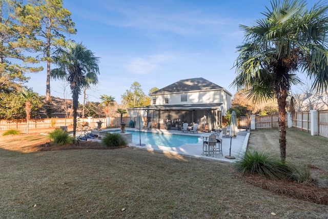 view of pool with a patio area and a lawn