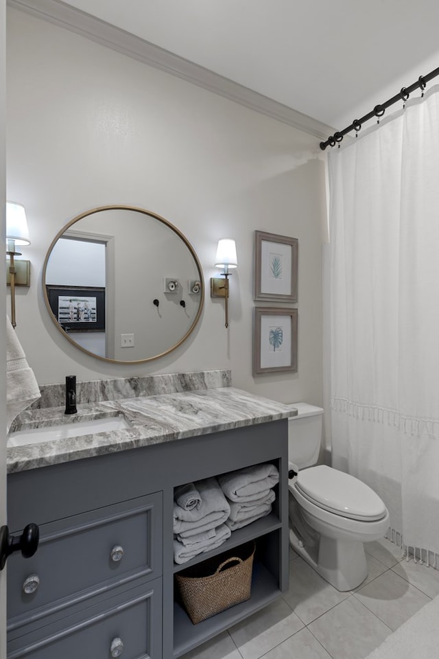 bathroom featuring toilet, vanity, tile patterned floors, and crown molding