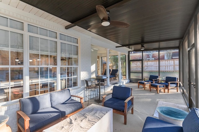 sunroom / solarium with ceiling fan and ornate columns