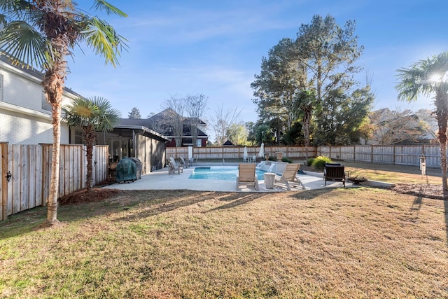 view of pool featuring a patio area and a yard