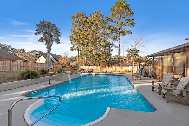 view of swimming pool featuring pool water feature and a patio