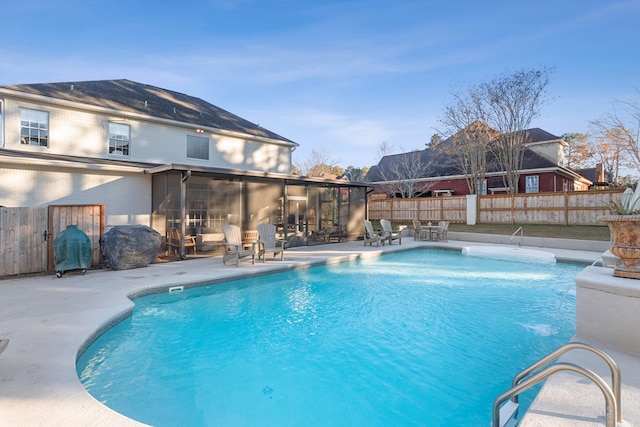 view of pool featuring grilling area, a patio area, and a sunroom