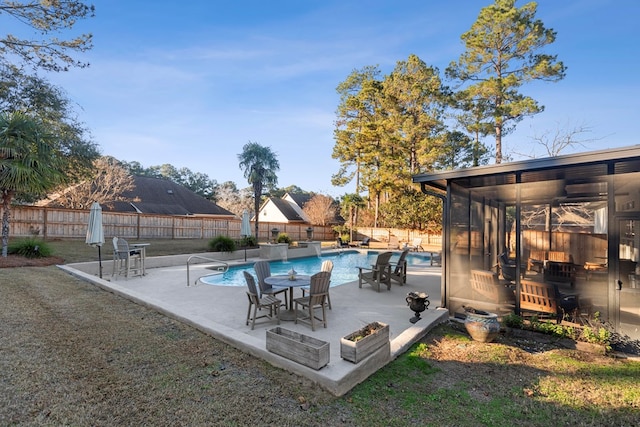 view of swimming pool with ceiling fan, a patio area, and a lawn