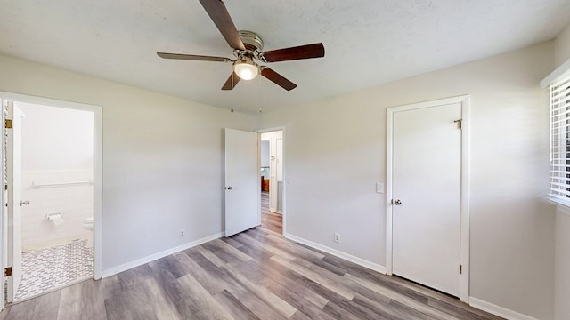 505 Massee Dr, Dothan, AL 36301 - unfurnished bedroom featuring wood finished floors, ensuite bath, and ceiling fan