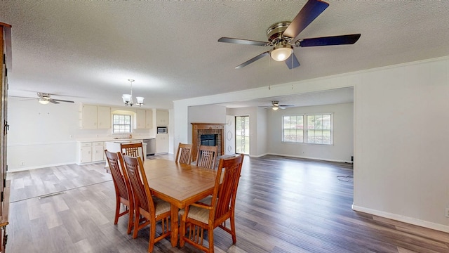 505 Massee Dr, Dothan, AL 36301 - dining area with a ceiling fan, healthy amount of natural light, a textured ceiling, light wood-style floors, and a brick fireplace