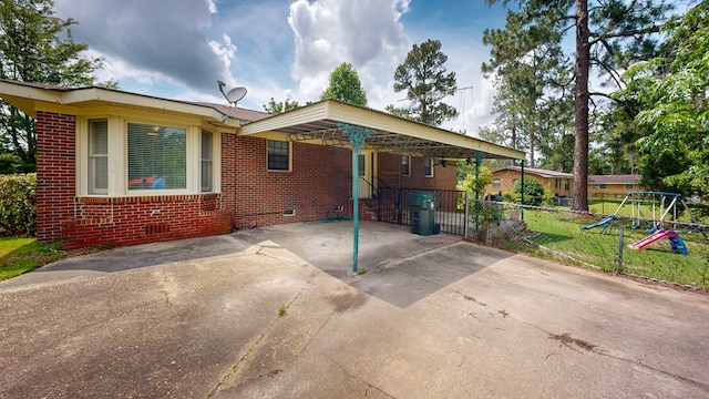 505 Massee Dr, Dothan, AL 36301 - view of front of property with crawl space, brick siding, driveway, a playground, and a carport