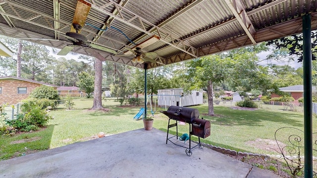 505 Massee Dr, Dothan, AL 36301 - fenced backyard featuring a ceiling fan, a patio, a grill, and a playground