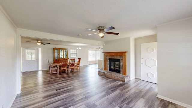 505 Massee Dr, Dothan, AL 36301 - living room with ceiling fan, ornamental molding, healthy amount of natural light, wood finished floors, and a brick fireplace