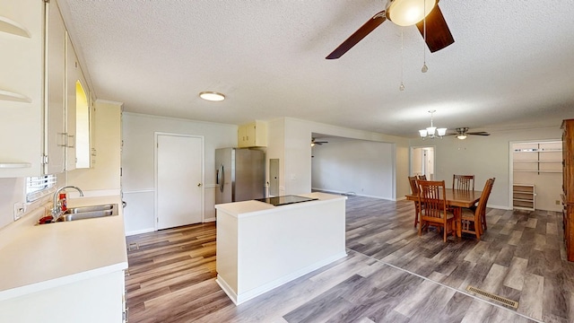 505 Massee Dr, Dothan, AL 36301 - kitchen with ceiling fan, stainless steel refrigerator with ice dispenser, a textured ceiling, light wood finished floors, and light countertops