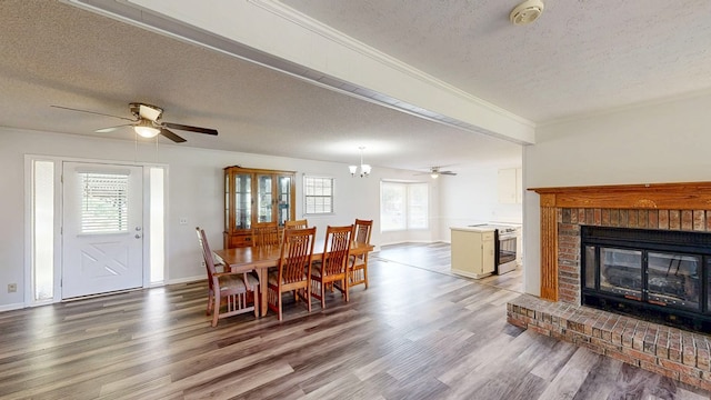 505 Massee Dr, Dothan, AL 36301 - dining room with a textured ceiling, wood finished floors, a ceiling fan, a fireplace, and crown molding
