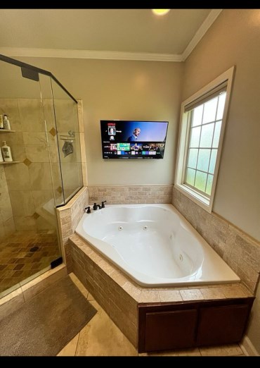 211 Paul Revere Run, Dothan, AL 36305 - bathroom with a shower stall, a jetted tub, ornamental molding, and tile patterned flooring