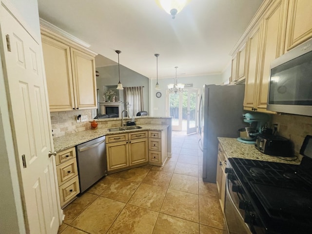 211 Paul Revere Run, Dothan, AL 36305 - kitchen with appliances with stainless steel finishes, backsplash, a peninsula, a chandelier, and cream cabinets