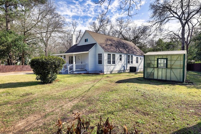 exterior space featuring a yard, an outbuilding, and central air condition unit