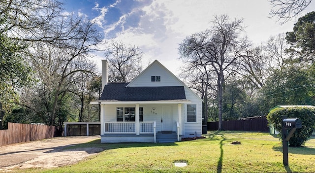 view of front of property with a porch, a carport, and a front yard