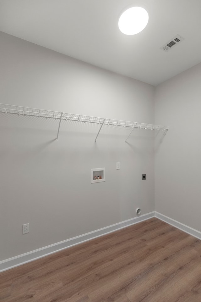 laundry room with hookup for a washing machine, hardwood / wood-style flooring, and electric dryer hookup