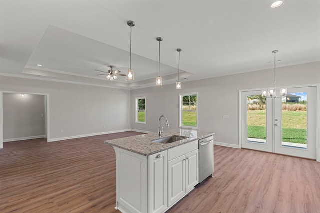 kitchen with dishwasher, light wood-type flooring, white cabinets, and sink