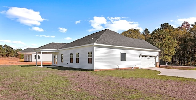 view of home's exterior with a garage and a lawn